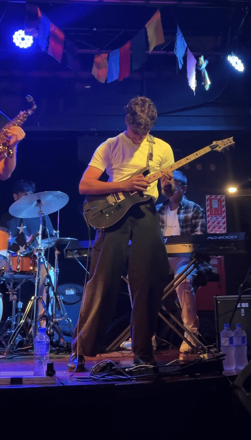 GIF of Milan playing the guitar